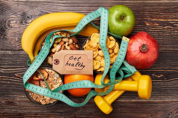 Fruits nuts and measuring tape Start living healthy