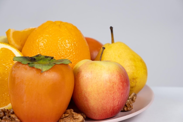 Fruits of orange and yellow colors apples persimmons