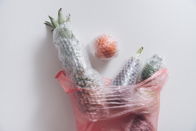 fruits and vegetables packaged in plastic wrap