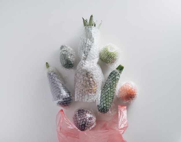 fruits and vegetables packaged in plastic wrap