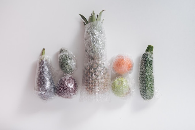 fruits and vegetables packaged in plastic wrap