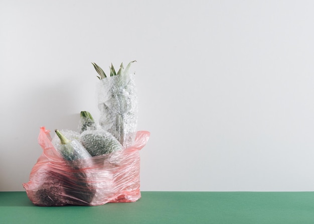 fruits and vegetables packaged in plastic wrap