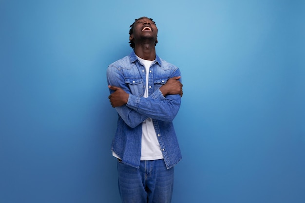 Frustrated feelings african man with dreadlocks in denim jacket