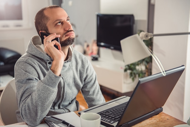 Frustrated man talking on smart phone