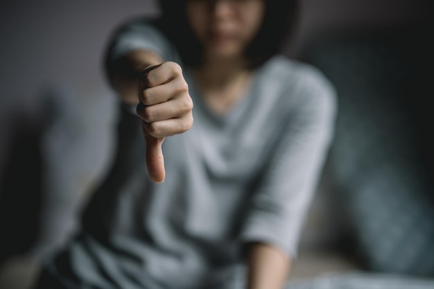 Frustrated woman showing thumbs down gesture