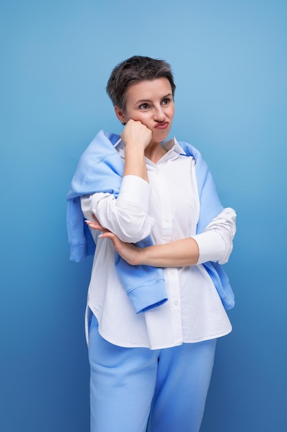 Frustrated young woman with short haircut in white casual shirt