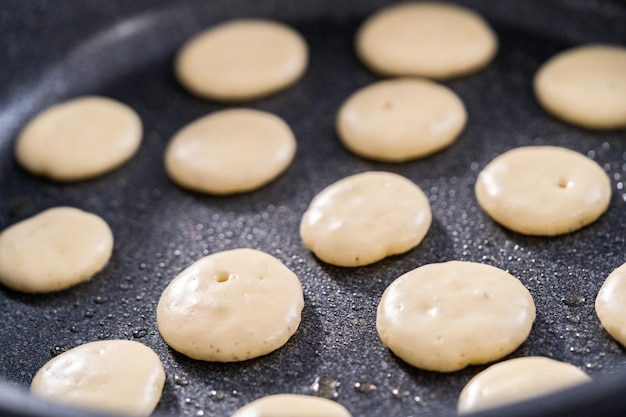 Frying mini pancake cereal in a nonstick frying pan.