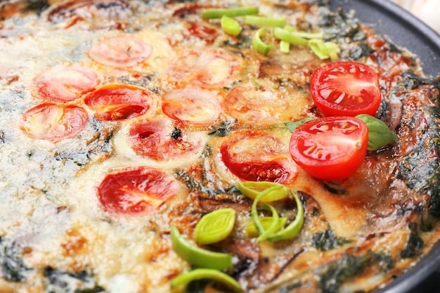 Frying pan with delicious spinach frittata closeup