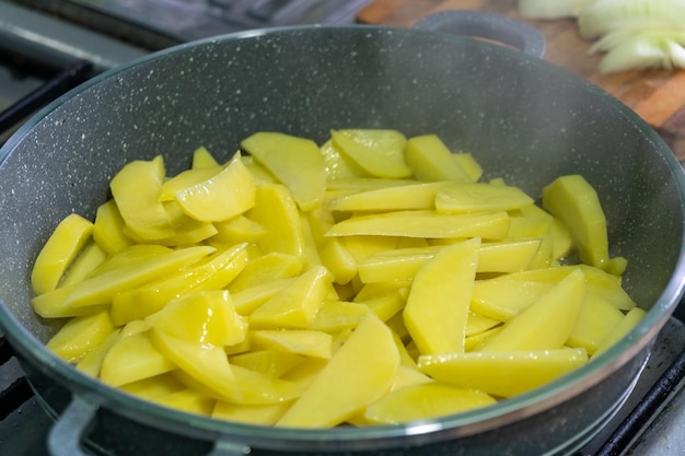 Frying pan with french fries appetizing rustic golden potatoes food