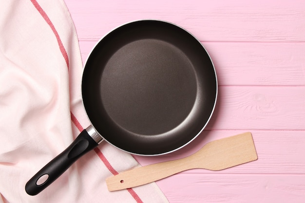 Frying pan and on the wooden table top view cooking