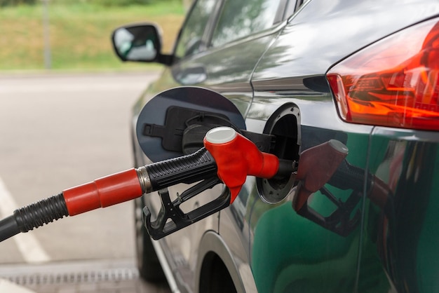 Fuel nozzle to refill fuel in car at gas station