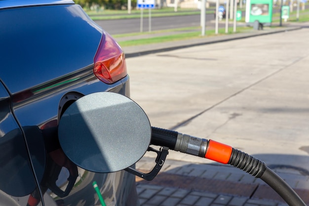 Fuel nozzle to refill fuel in car at gas station