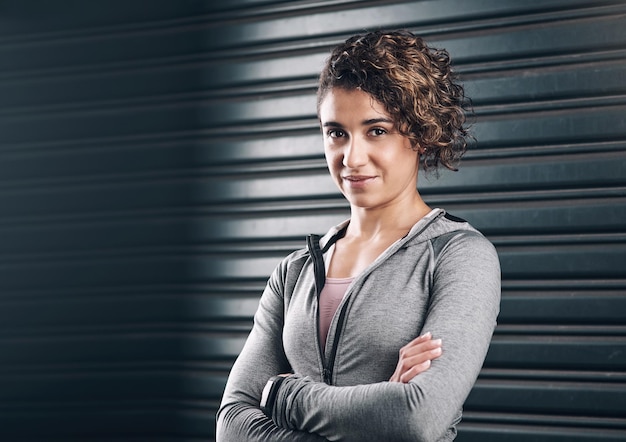 Fuelled by ambition Portrait of a young beautiful woman folding her arms against a black background