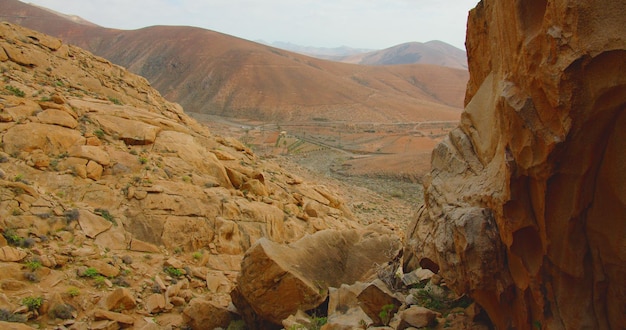 Fuerteventura Canary Islands Spain Arid dry desert mountains empty valley and gorge Trikking path Barranco de las Penitas Lifeless soil Slow motion High quality 4k