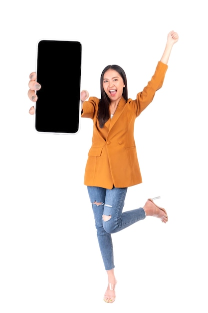 Full body length photo portrait of beautiful Asian young woman Excited surprised girl showing big smart phone with blank screen white screen isolated on white background Mock Up Image