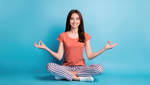 Full body photo of positive cheerful girl sitting floor legs crossed meditating yoga and smiling