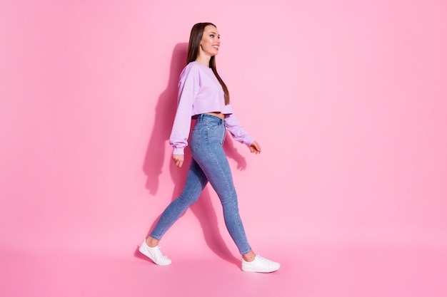 Full body profile side photo of nice attractive friendly girl go walk look good copyspace meet friend holiday weekend isolated pink color background