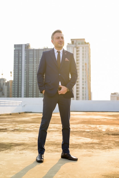 Full body shot of mature businessman in suit in the city