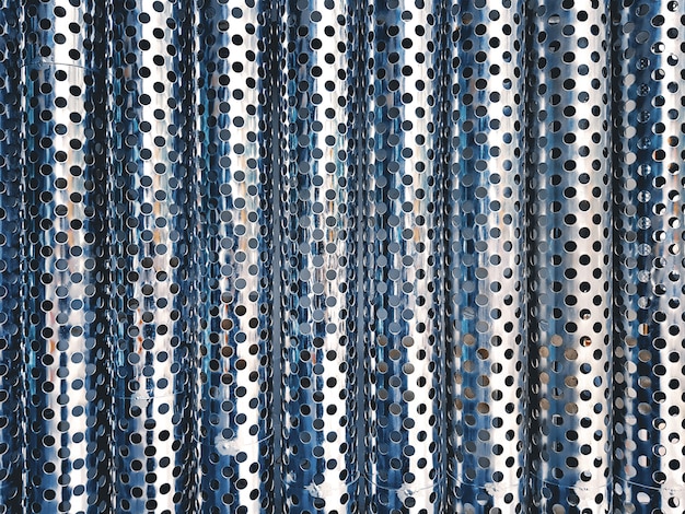 Full Frame Background of Shiny Metallic Corrugated Perforated Sheet