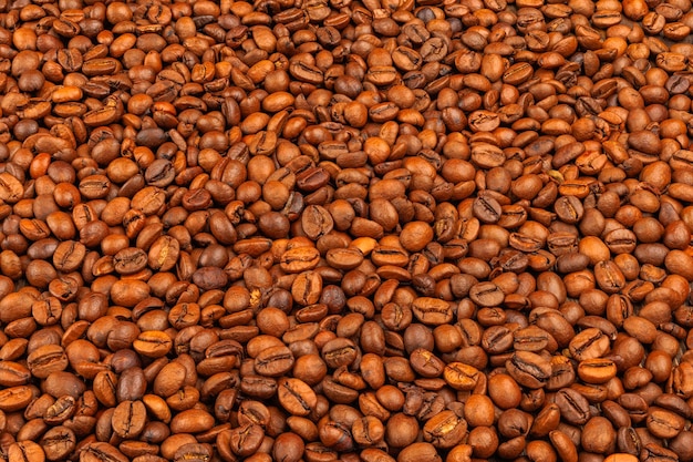 Full frame background and texture of roasted coffee beans on flat wooden surface in high angle view