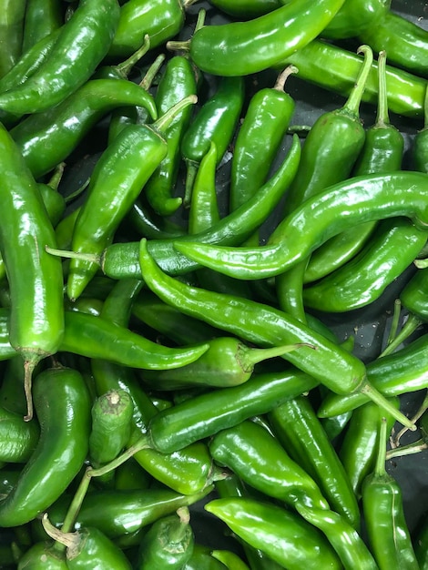 Full frame shot of green chili peppers for sale in market