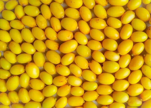 Photo full frame shot of yellow neem fruits