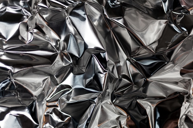 Full frame take of a sheet of crumpled silver aluminum foil