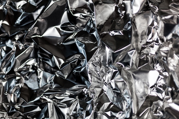 Full frame take of a sheet of crumpled silver aluminum foil