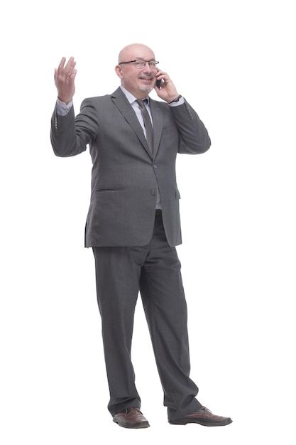 In full growth. business man with a smartphone.isolated on a white background.