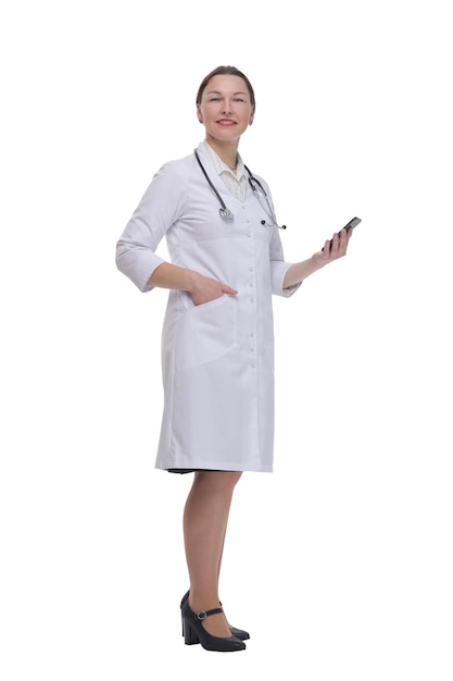 In full growth.female doctor with a smartphone. isolated on a white background.