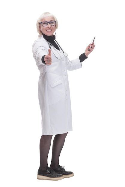 In full growth. female doctor with a smartphone. isolated on a white background.