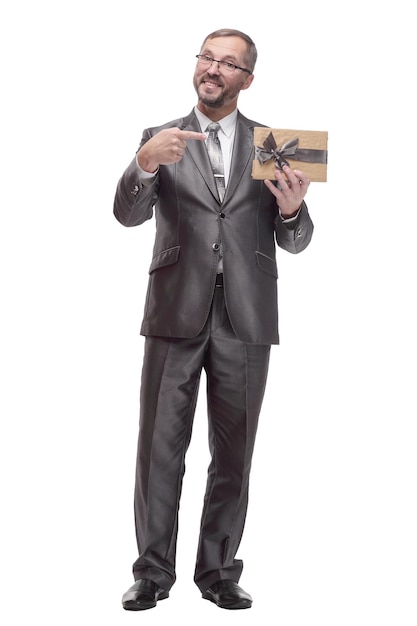 In full growth.happy business man with a gift box. isolated on a white background.