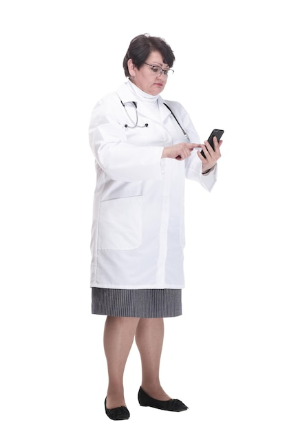 In full growth senior female medic with a smartphone