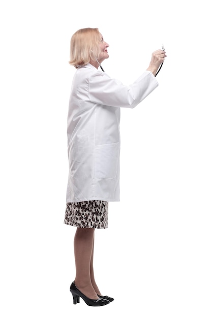 in full growth smiling female doctor with a stethoscope in her hand isolated on a white background