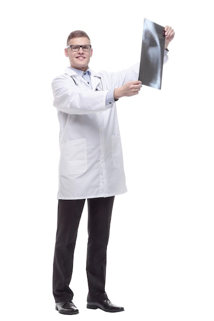 In full growth. young doctor with an x-ray. isolated on a white background.