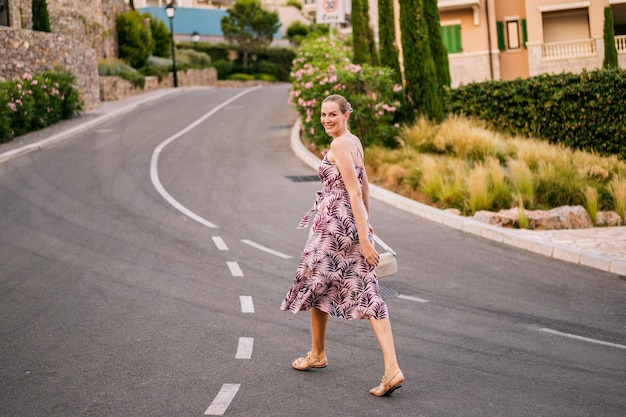 Full lenght image of stylish woman walking at Montenegro and enjoy her summer vacation