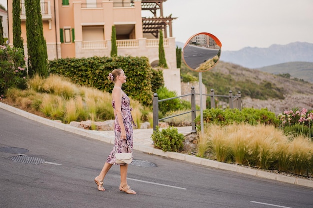 Full lenght image of stylish woman walking at Montenegro and enjoy her summer vacation