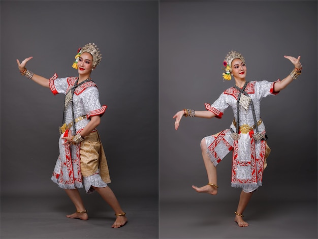 Full length of Asian Woman wear Thai Traditional Costume Dancer with beautiful design dress Khon dance is Act Play Royal of Thailand Studio lighting over Gray background isolated