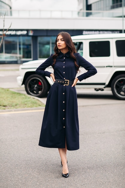 full length of beautiful brunette young woman in long dark dress