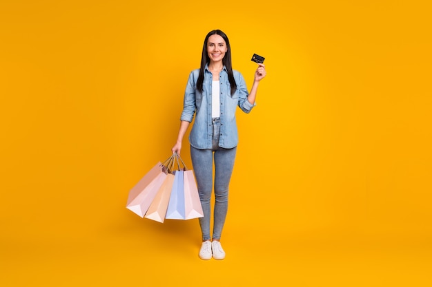 Full length body size view of girl carrying new bargain paying credit card