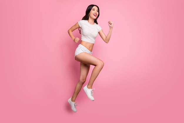 Full length body size view of her she nice attractive lovely charming winsome glamorous cheerful cheery wavy-haired girl jumping running fast motion isolated over pink pastel color wall