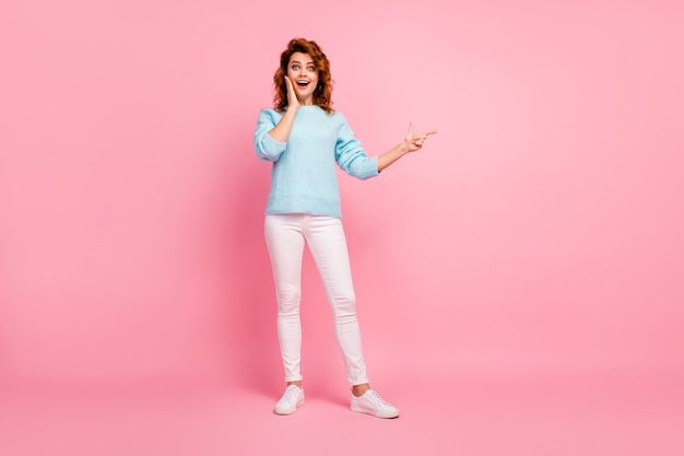 Full length body size view of her she nice-looking attractive lovely glad amazed cheerful cheery wavy-haired girl showing copy space new novelty isolated over pink pastel color background