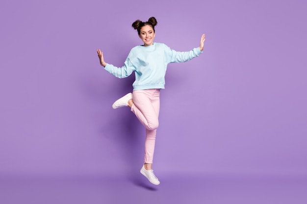 Full length body size view of nice attractive pretty slim fit glad cheerful cheery girl jumping having fun dancing leisure isolated on violet purple lilac bright vivid shine vibrant color background