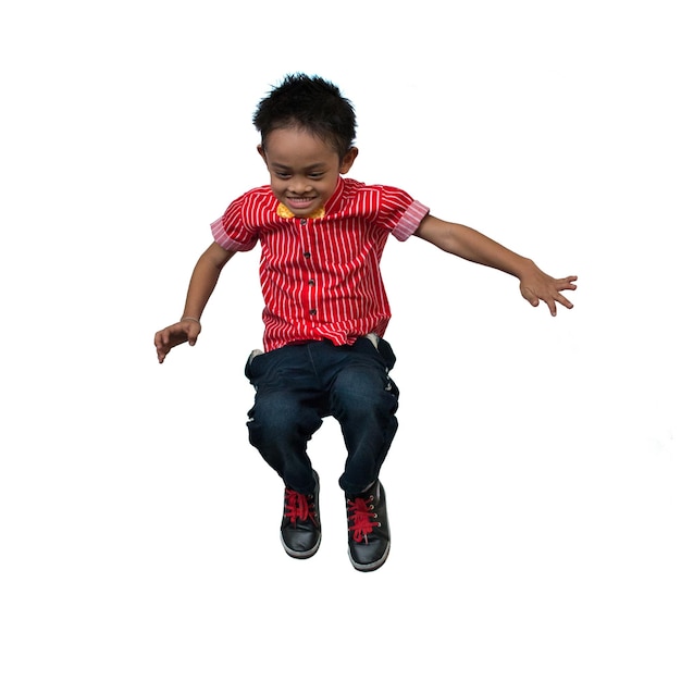 Full length of boy jumping against white background