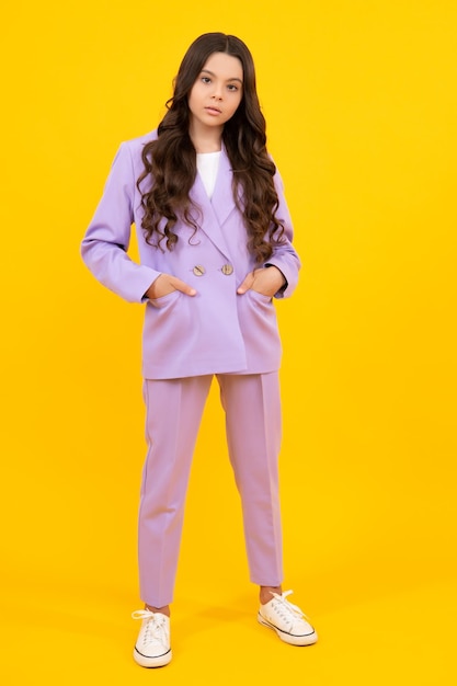 Full length of cheerful teenager child girl wearing comfy trendy fashion clothes isolated over yellow background