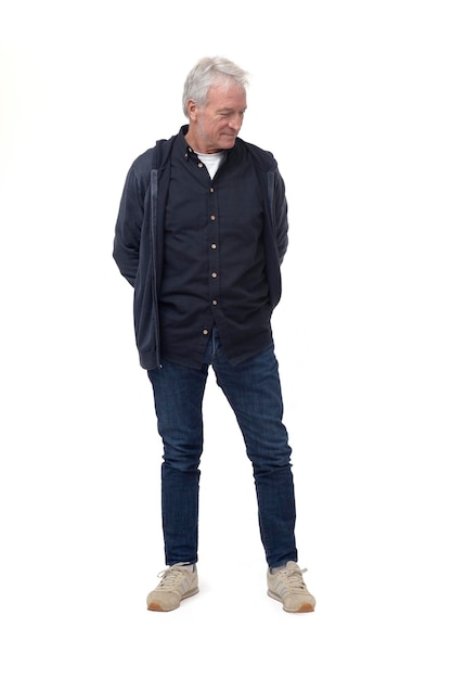 Full length front view portrait of a man looking down at the ground on white background