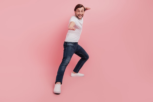 Full length photo of handsome attractive guy ready to kick exercise sport isolated pink color background