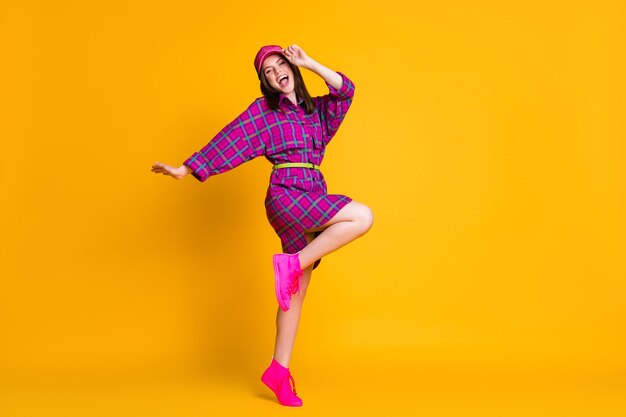 Photo full length photo of nice young person dancing arm touch headwear isolayed on bright yellow color background