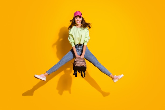 Full length photo of pretty funky energetic lady hold backpack jump