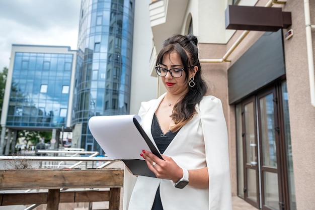 Full length photo of young attractive businesswoman outdoors in city center